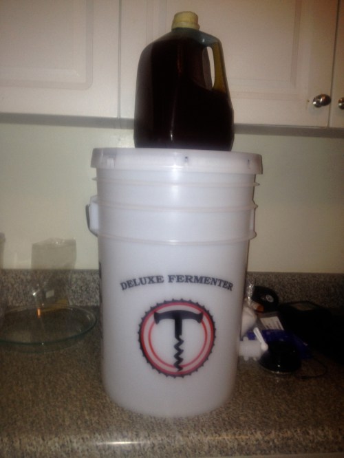 Twelve pounds of wild honey atop a 6.5 gallon fermenter.