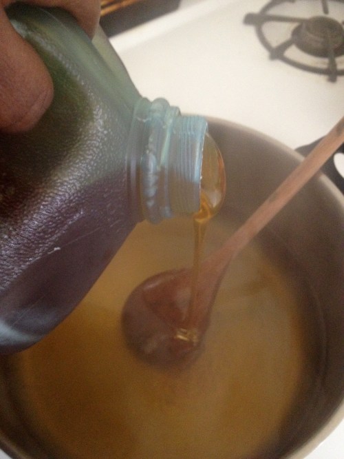 stirring honey into hot water for mead